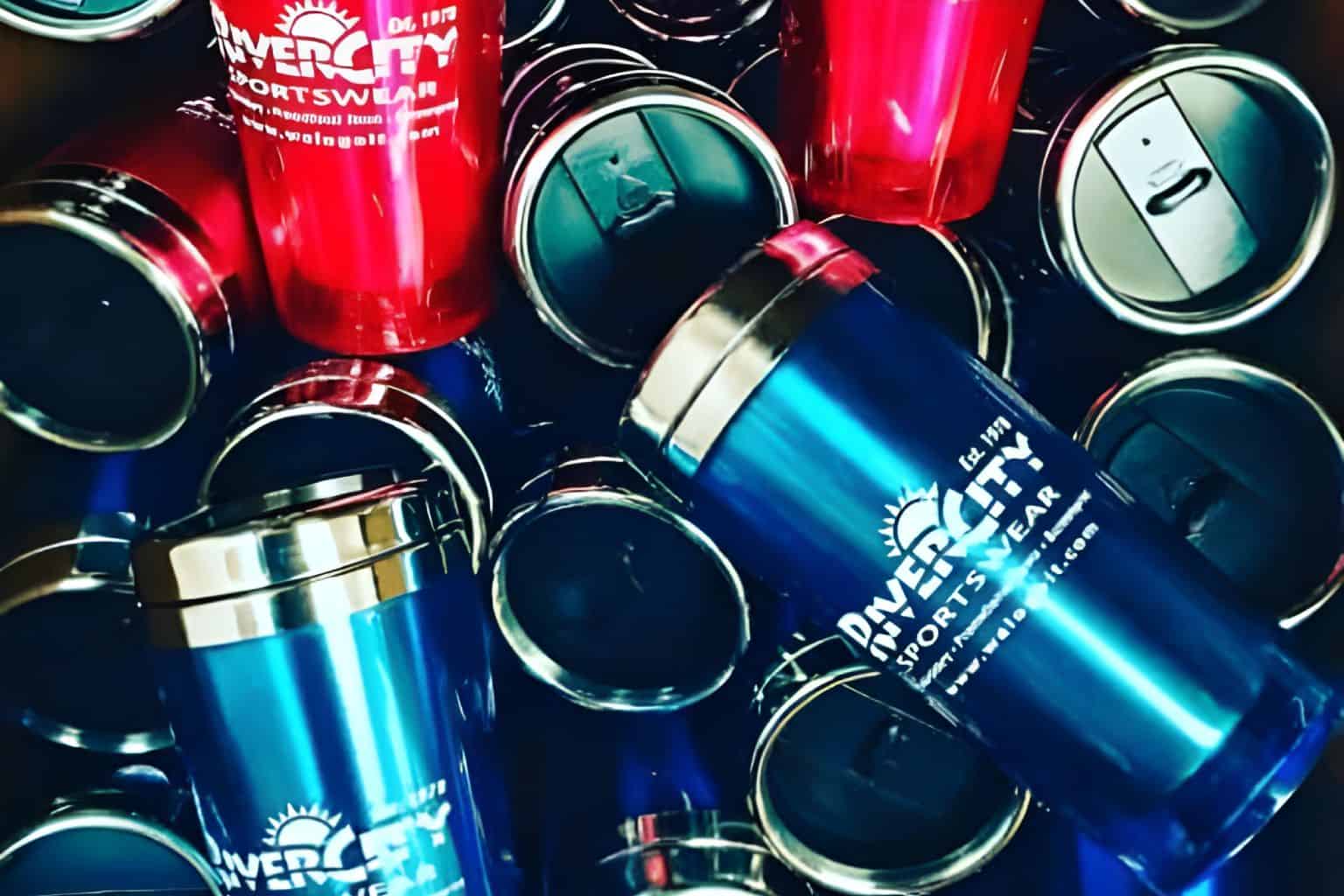 A pile of customized tumblers and mugs.